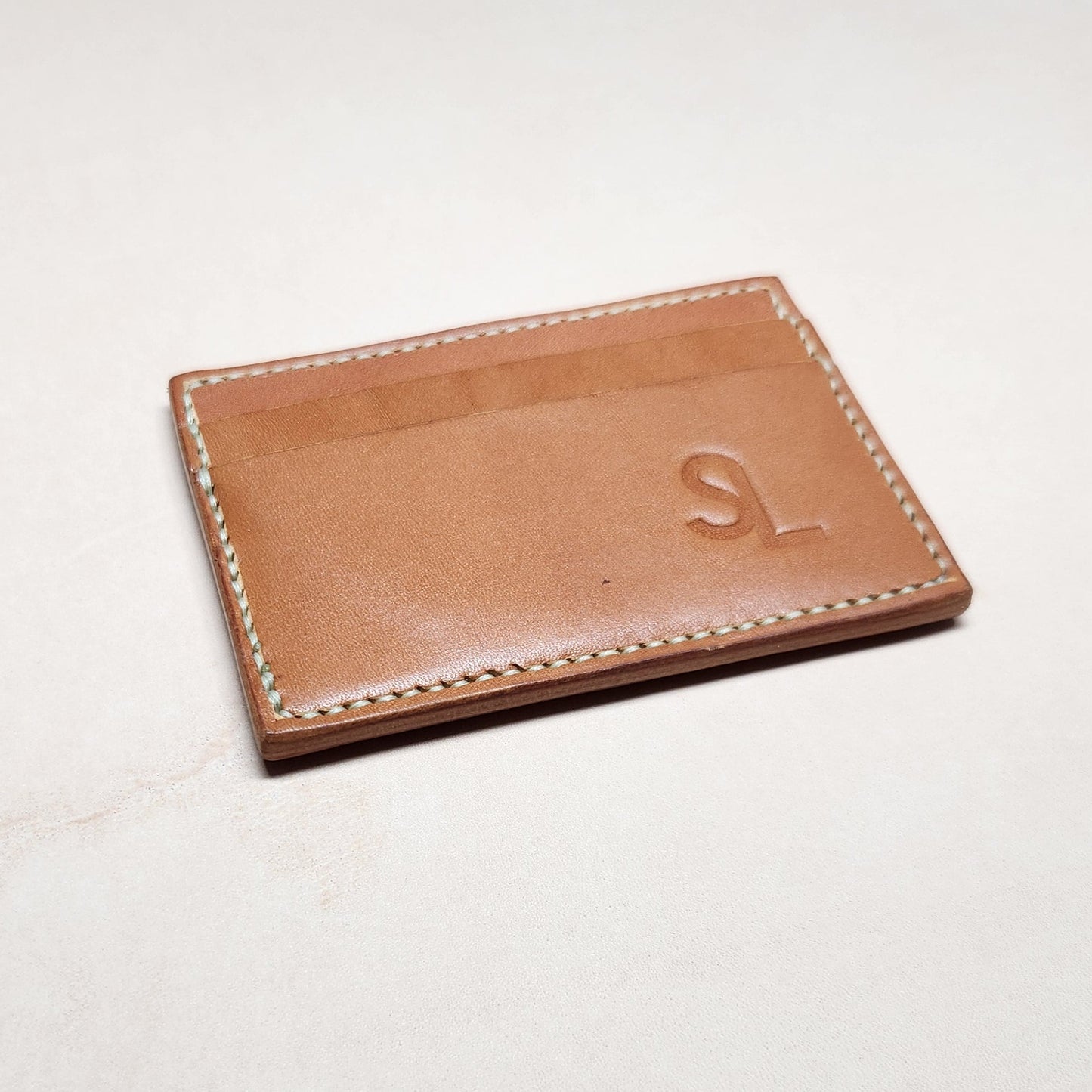 Brown leather wallet on a light gray background